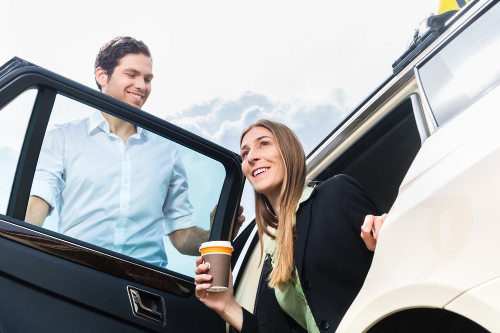 Young,Businesswoman,Gets,Out,Of,Taxi,,She,Holding,A,Cup